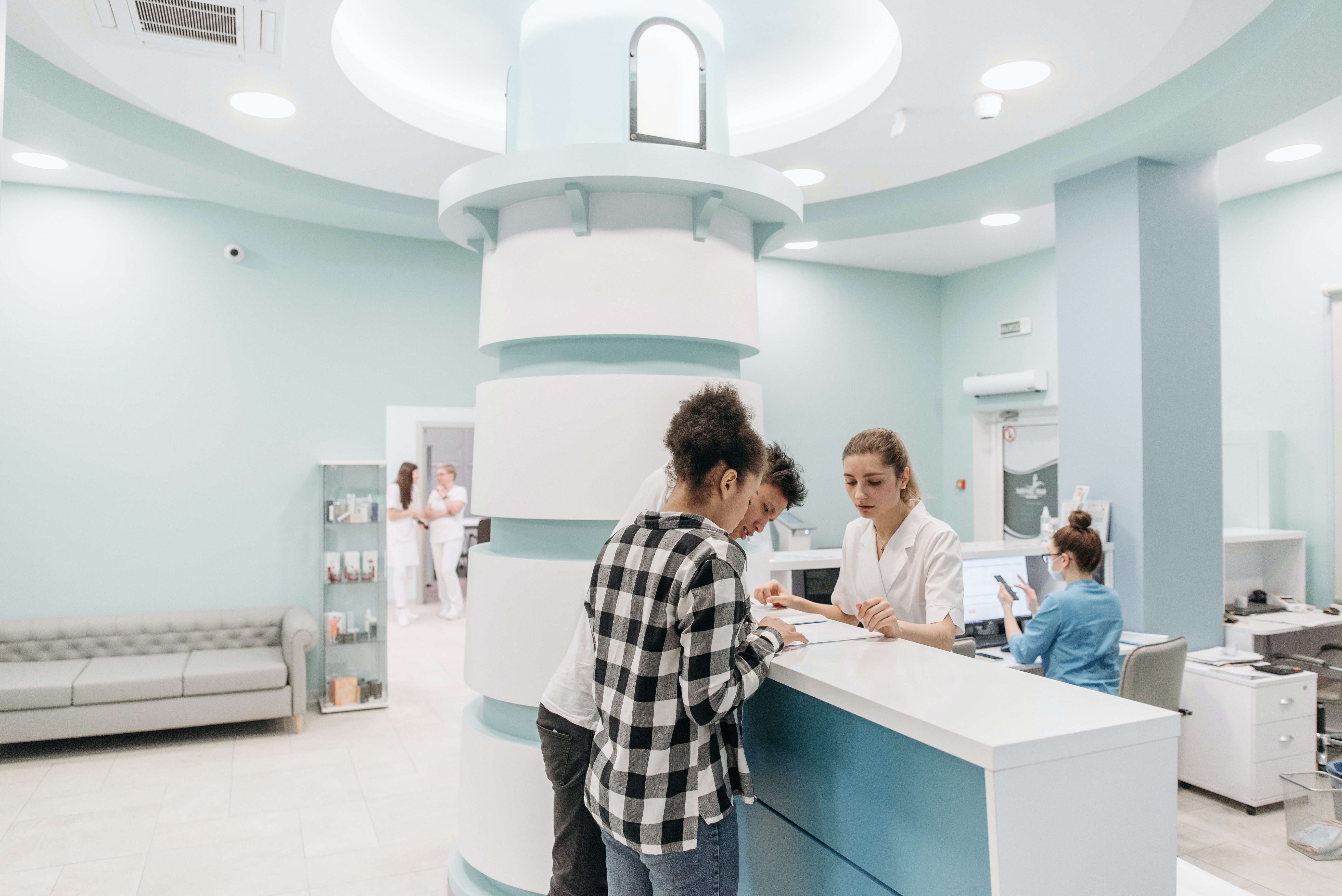 Couple talking to nurse at desk