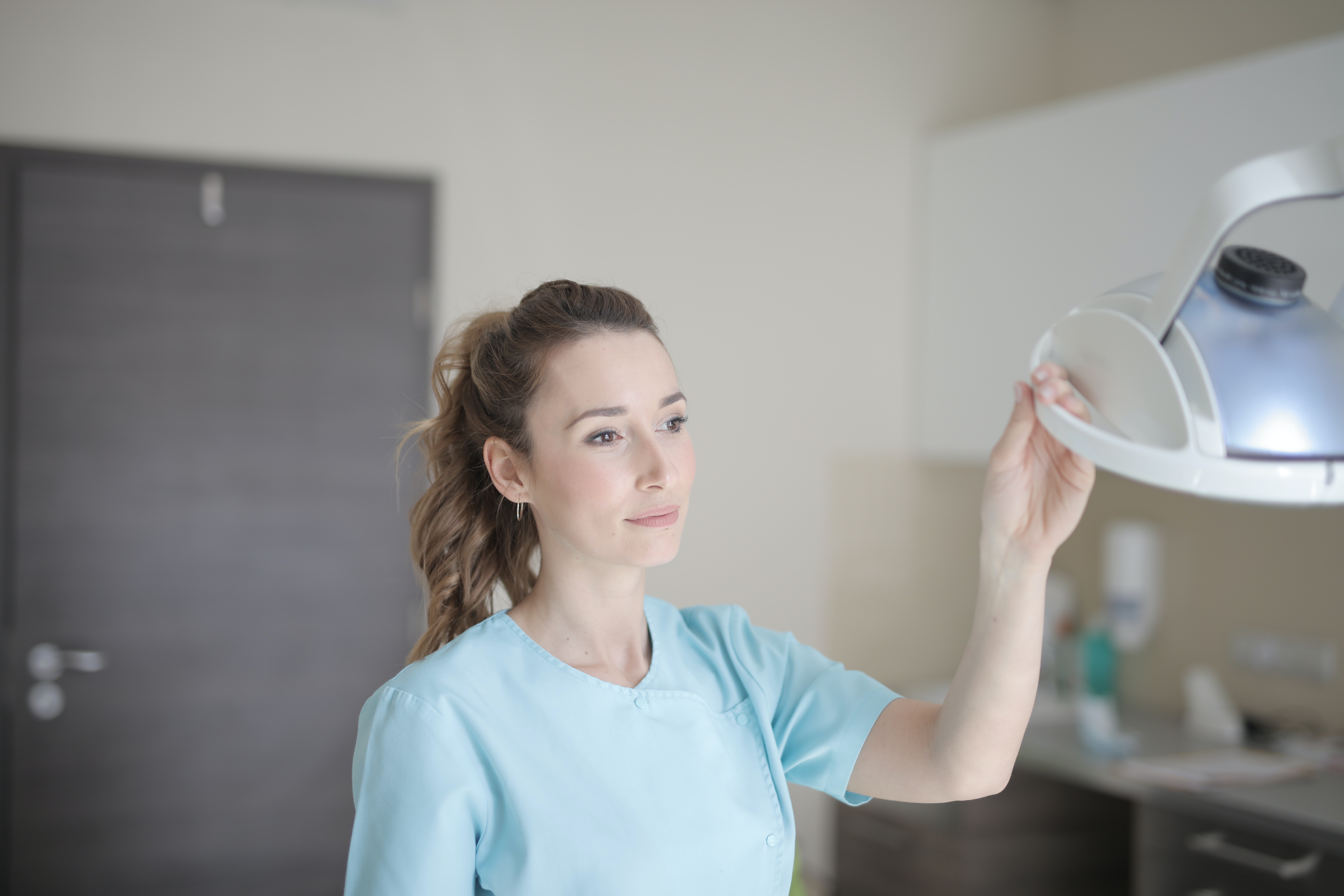 serious young female doctor in uniform standing in modern clinic