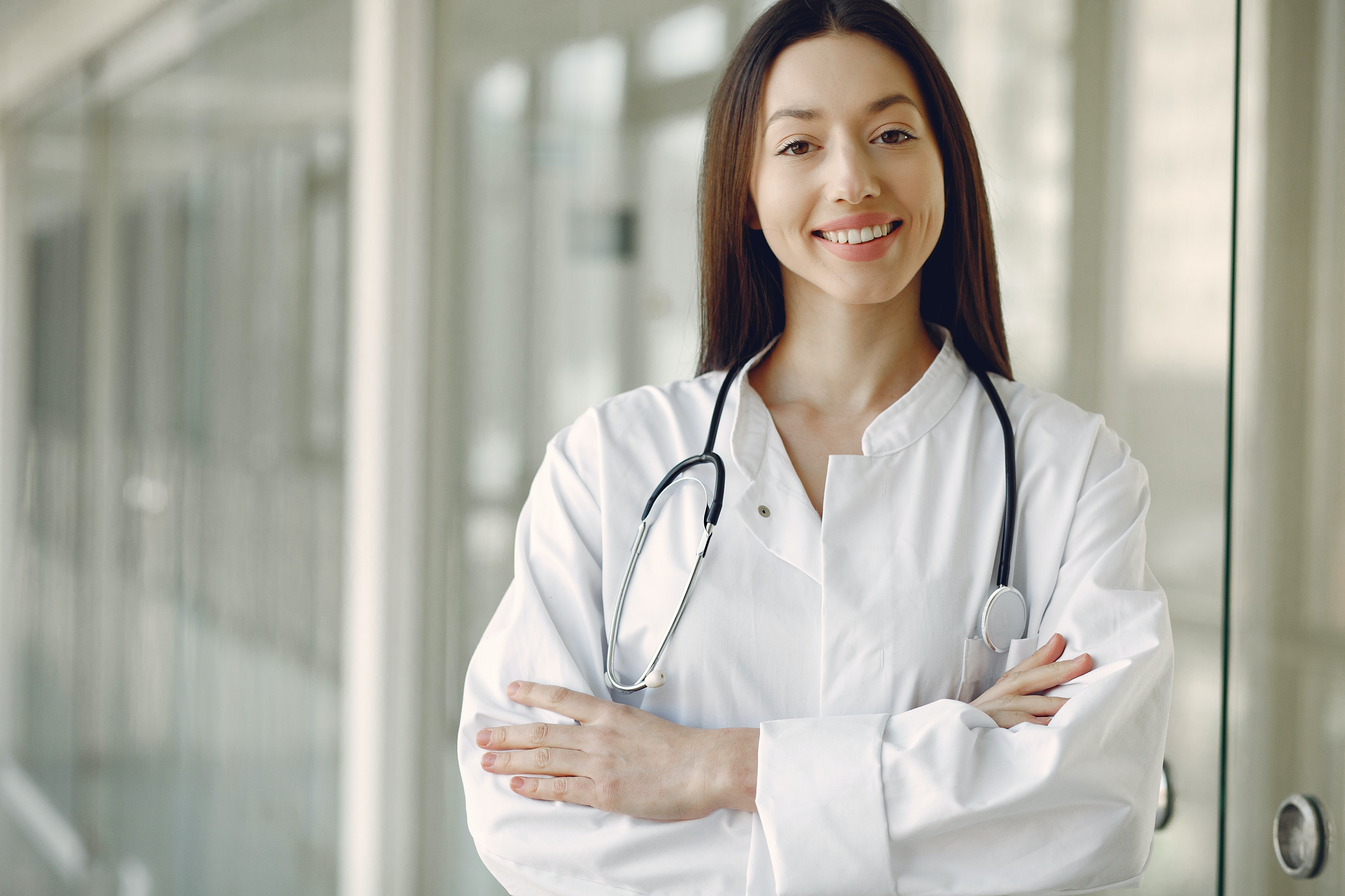 doctor in medical uniform with stethoscope standing in clinic corridor