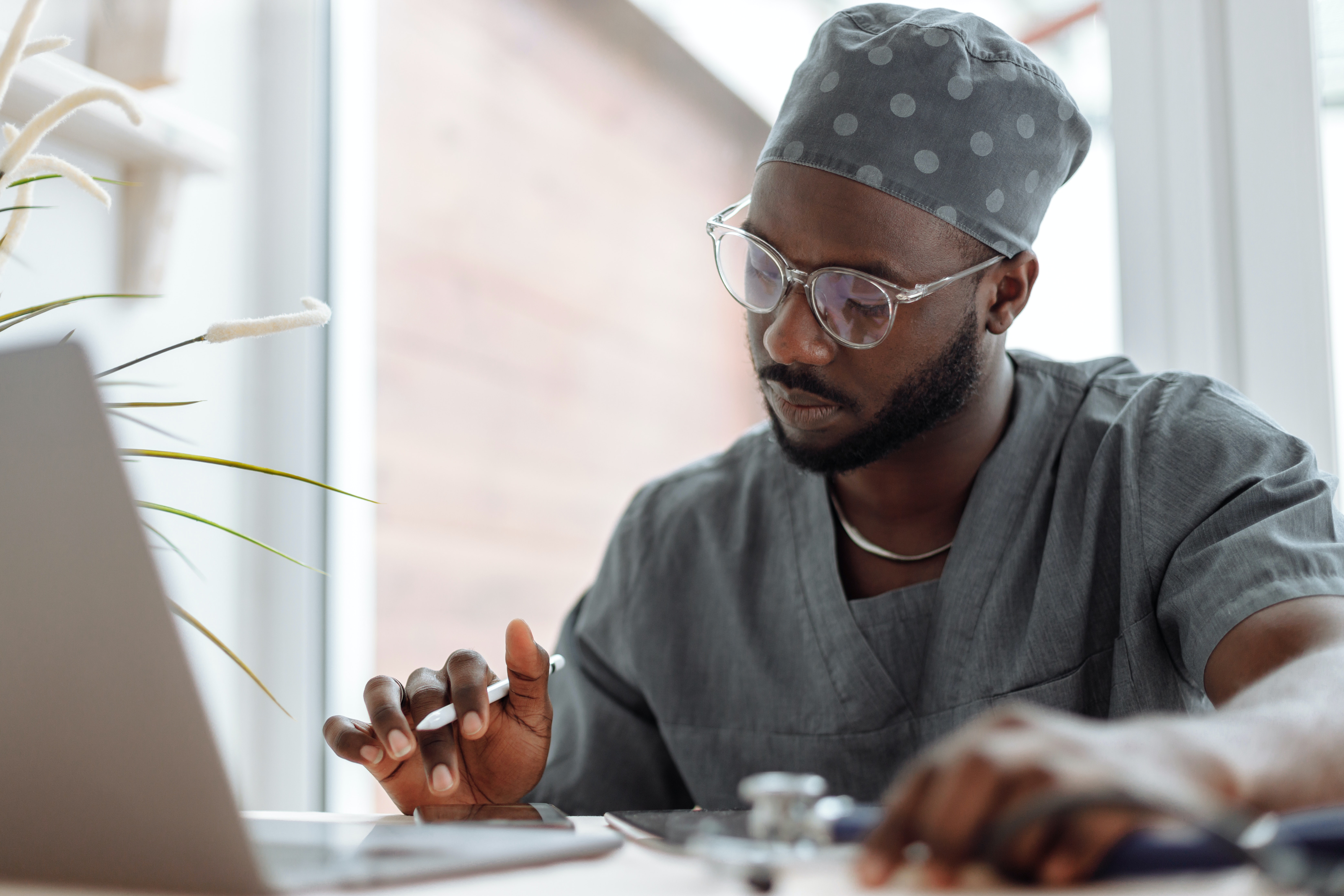 A Medical Practitioner Using Electronic Gadgets at Work